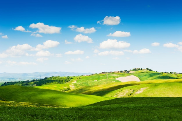 Green fields and blue sky. Beautiful Tuscany landscape, province of Certaldo, Italy