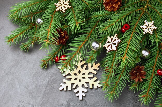 Green fir tree branches composition with christmas decorations