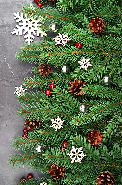 Green fir tree branches with Christmas decorations