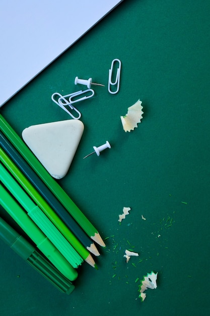 Green Flat lay Back to school concept, School and office supplies on with copy space. Lots of different stationery items on colorful background