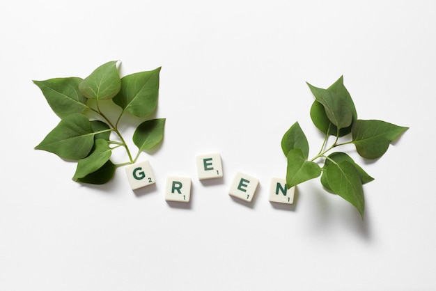 Green formed of scrabble tiles with tree branches