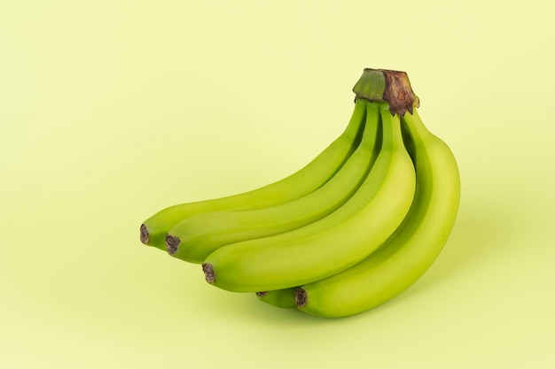 Green fresh bananas on a green background