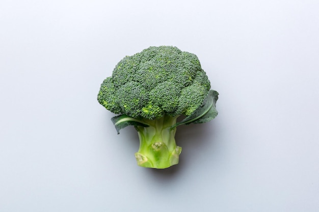 Green fresh broccoli background close up on colored table Vegetables for diet and healthy eating Organic food