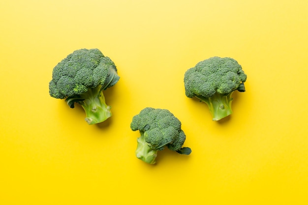 Green fresh broccoli background close up on colored table Vegetables for diet and healthy eating Organic food