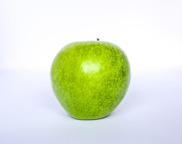 Green fresh ripe apple on white background.