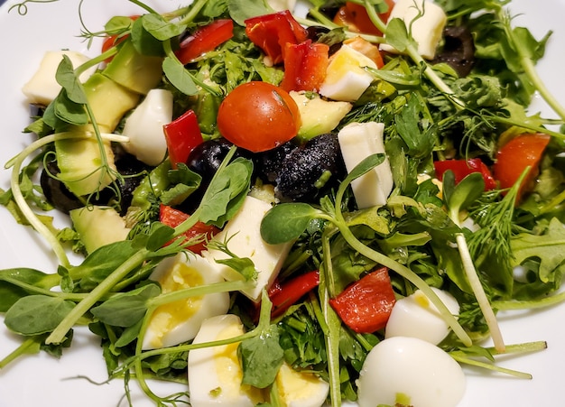 Green fresh salad in a plate vegetables herbs fish