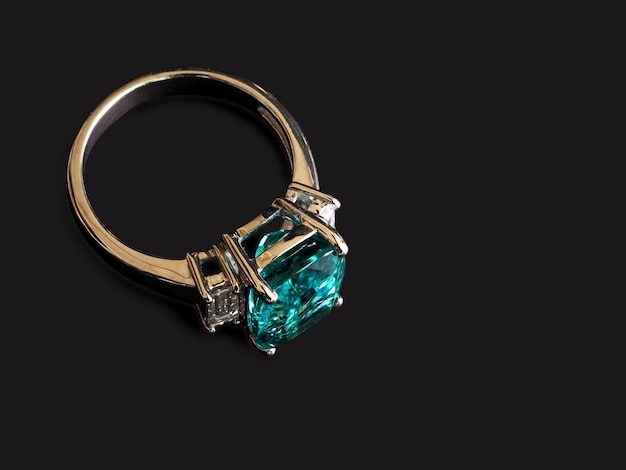 green gem ring with white diamond on black