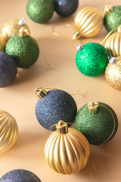 Green gold and blue Christmas baubles on a beige background festive xmas composition