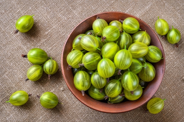 Green gooseberries in ceramic bowl