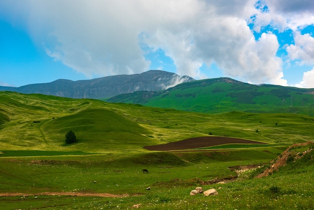 Green hills and beautiful blue sky with clouds