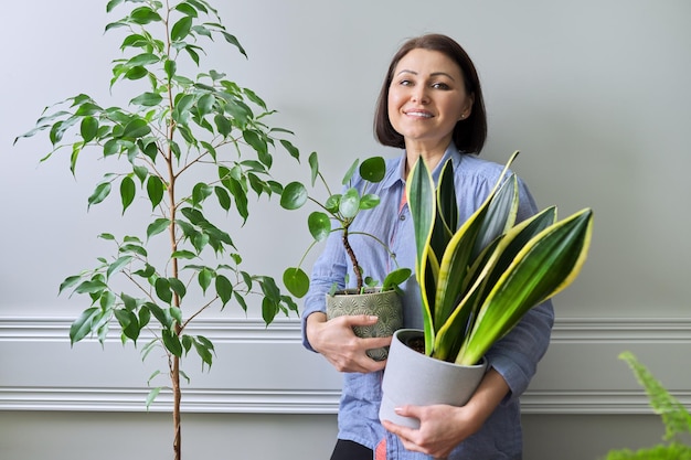 Green hobby indoor houseplants woman with plants in pots