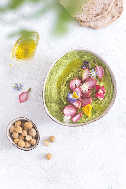 green hummus with baked radish and edible flowers