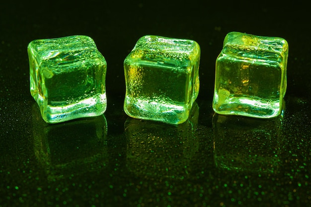 Green ice cubes on black background