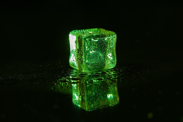 Green ice cubes on black background