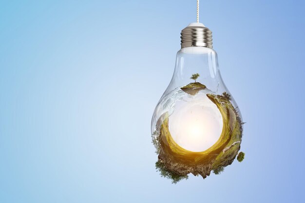 Green Landscape inside a light bulb image. Mixed media