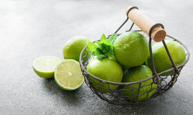 Green Limes with fresh mint leaves in basket