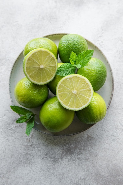 Green Limes with fresh mint leaves on plate