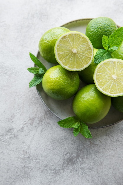 Green Limes with fresh mint leaves on plate