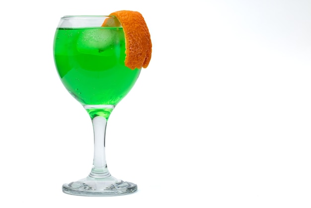 Green liquor glass with orange peel.