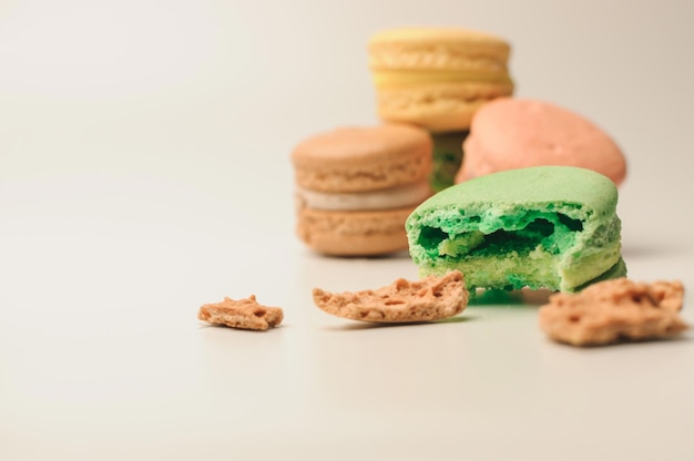 green macaroon in the foreground lies a bite.