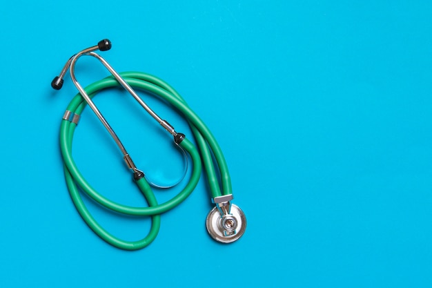 green medical stethoscope with copy space