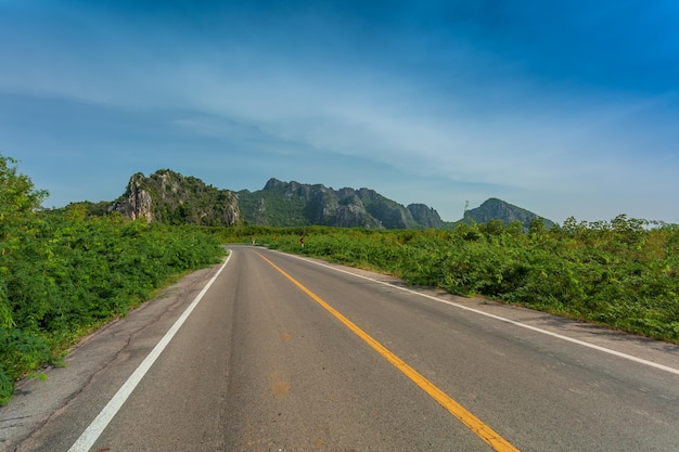 Green mountain and empty asphalt highway natural scenery Asphalt highways and mountains under the b