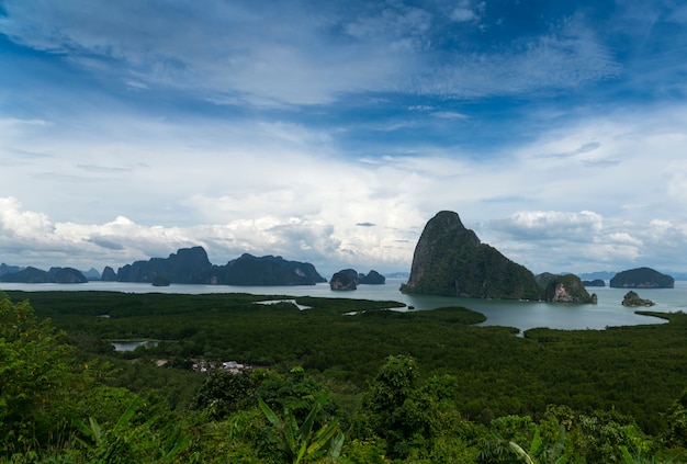 Green mountainous islands swim in the azure sea. View from the top of the island.