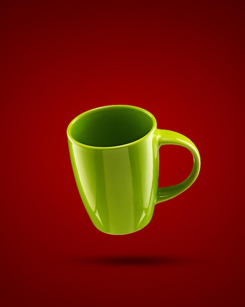 Green mug on red background with vignette