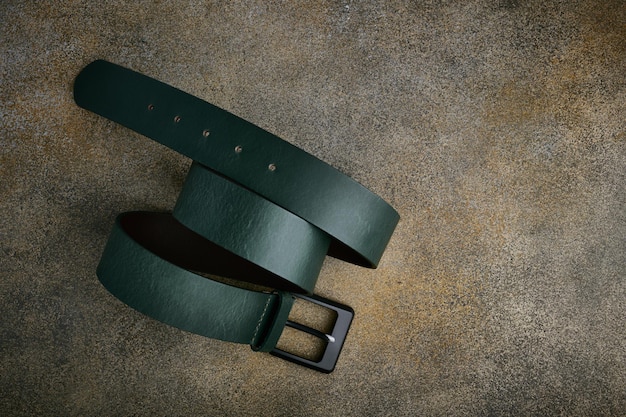 Green natural leather belt with black buckle closeup