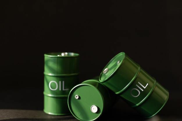 green oil tin barrels on black background.