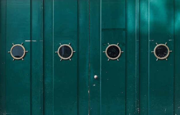 Green old wooden painted door with windows grunge texture for background