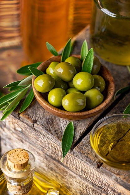 Green olives in wooden bowl