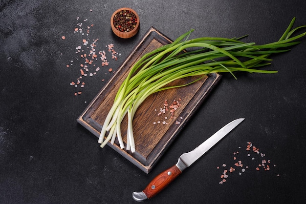 Green onion or scallion on wooden board fresh spring chives