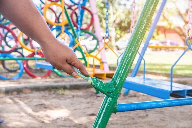 Green painted steel, painting of child playing outdoor, community care job