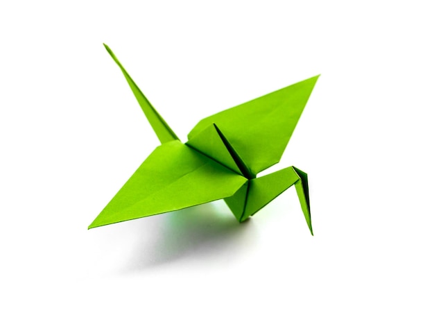 Green paper crane origami isolated on a white background