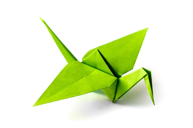 Green paper crane origami isolated on a white background