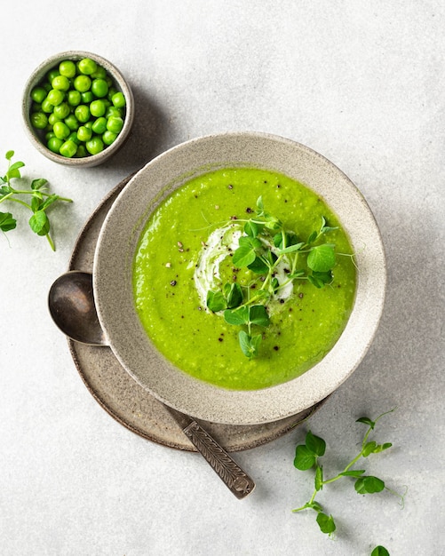 Green pea soup on gray concrete surface top view