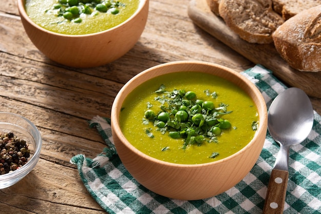 Green pea soup in a wooden bowl