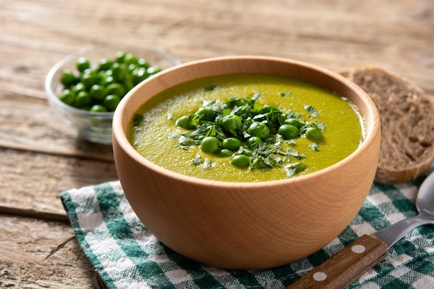 Green pea soup in a wooden bowl