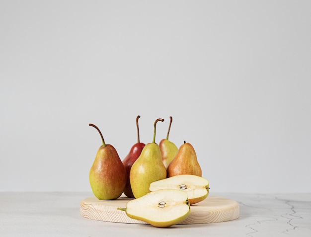 Green pears cut in half and sliced to pieces a white background