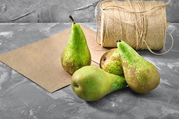 Green pears on a gray background with a paper bag for delivery food delivery environmental packaging