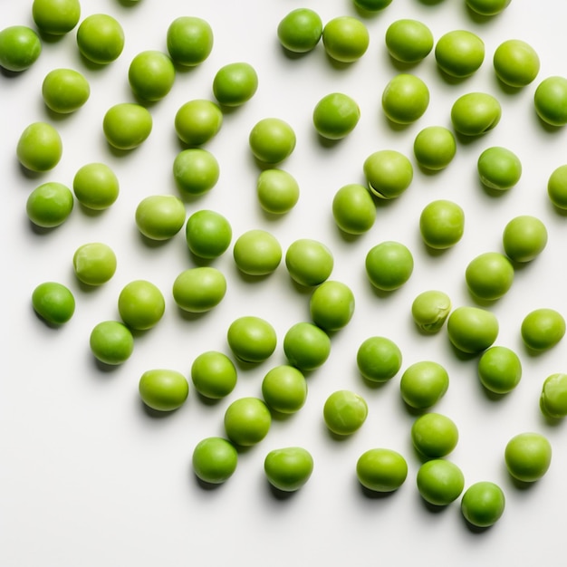 Green peas are scattered on a white background.