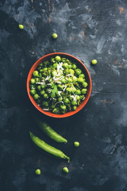 Photo green peas dry recipe or matar ki sookhi sabji, served in a serving pan or terracotta bowl. selective focus