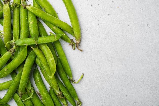 Green peas Freshly harvested on gray stone table background top view flat lay with copy space for text