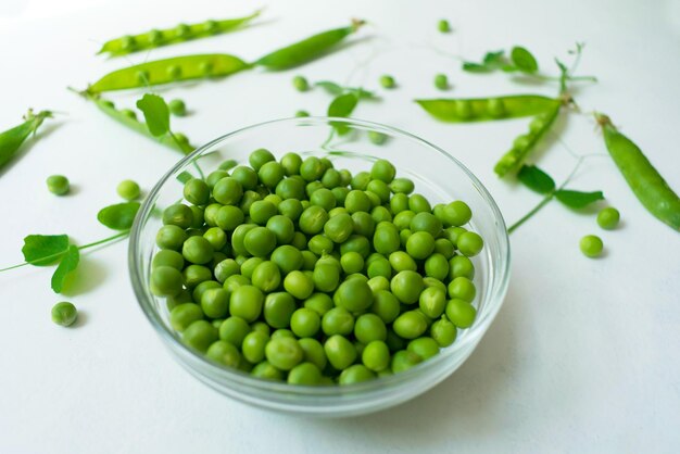 Green peas in a plate on the table Top view