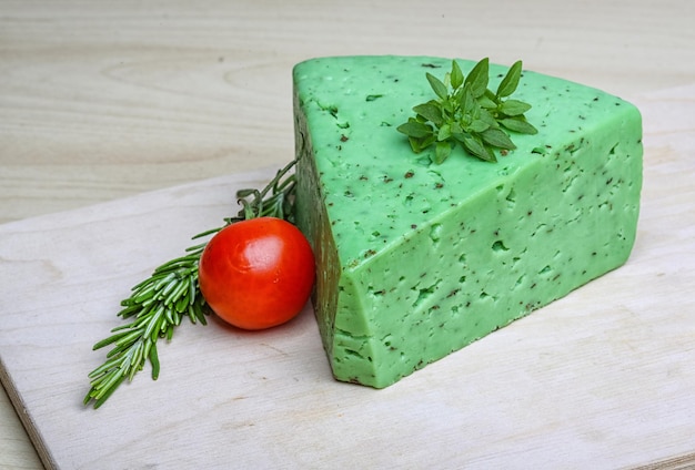 Green pesto cheese with rosemary basil leaves