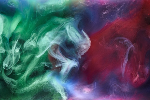 Green pink smoke on black ink background colorful fog abstract swirling touch ocean sea acrylic paint pigment underwater