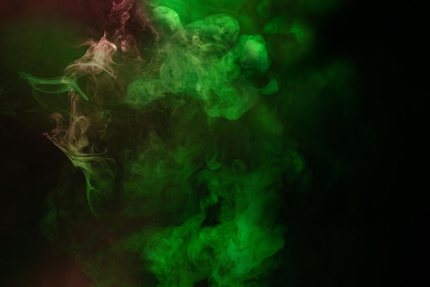 Green and pink steam on a black background Copy space