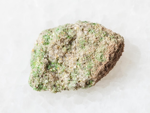 Green Pintadoite crystals in raw stone on white