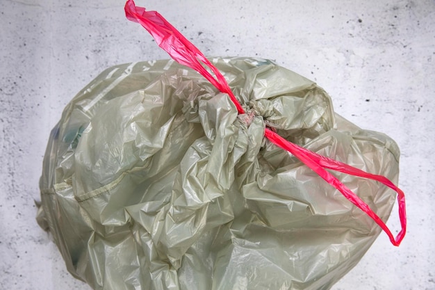 Green plastic garbage bag for plastic waste ready to recycle waste management top view